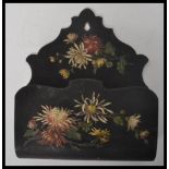 A 19th century Victorian ebonised hand painted folk tolewre letter rack having painted floral