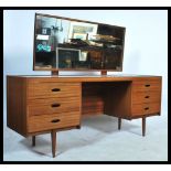 A retro 20th century teak wood dressing table having reeded drawer fronts with central kneehole