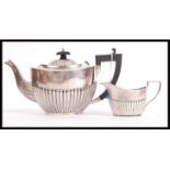 A part silver hallmarked tea service to include teapot and creamer, Birmingham assay marks, makers