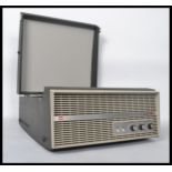A vintage portable four speed record player by Murphy, dials and speaker to front, BSR deck to the