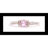 A 10ct white gold diamond and pink stone clusuter ring. Marked 10k. tests 10ct gold. Weight 1.2g.