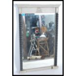 An Empire / Louis style French Pier mirror having a painted frame with ebonised twist columns. The