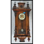 A 19th century Victorian walnut vienna regulator wall clock in the manner of Gustav Becker having an