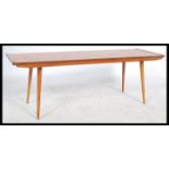 A 1970's retro teak coffee table, with a rectangular overhanging top raised on shaped supports