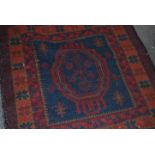 A Persian Islamic floor rug having a deep red and