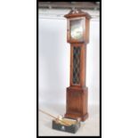 A 20th century antique style oak longcase grandfather clock with brass face and roman numeral