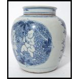 A 18th / 19th century Oriental Chinese ginger jar having a flat lid with concentric blue circles.