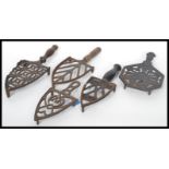 A collection of five ( 5 ) 19th century Victorian cast iron ornate trivets to include Irons and