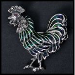 A silver and plique a jour brooch in the form a cockerel with pin to verso. Weighs 11.4 grams.