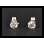 A pair of white gold and diamond stud earrings of approx 83 points. Complete in presentation box.