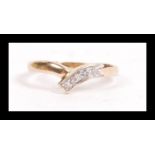 A hallmarked 9ct gold and diamond wishbone ring having illusion set accent diamonds. Hallmarked