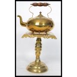 A 19th century brass pedestal trivet and kettle. The pierced top trivet on turned column support,