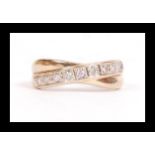A hallmarked 9ct gold and diamond band crossover ring set with 9 x 2pt diamonds. Hallmarked