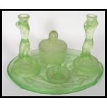 An Art Deco Lalique inspired green pressed glass Dressing Table Set consisting of tray, two
