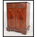 A 20th century Georgian style flame mahogany hi-fi / entertainment cabinet having a hinged top and