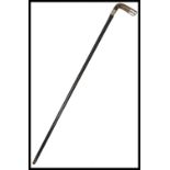A 19th century silver hallmarked walking stick cane having a tapering ebonised shaft with shaped