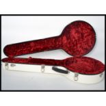 A good quality contemporary Calton white banjo case with red velvet lined sectional interior. Makers