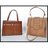 Two vintage mid 20th century ladies handbags to include a pale leather bag with detachable