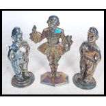 A pair of large cast metal lustre fireside companions / door stops in the form of Dutch Boys and a