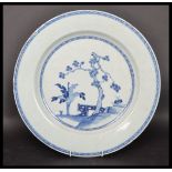 An 18th century Chinese Qing Long blue and white large plate hand painted depicting a blossoming