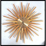 A vintage retro 20th century Paico teak sunburst / atomic wall clock