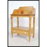 A Victorian pine country washstand being raised on turned legs having gallery top with washbowl