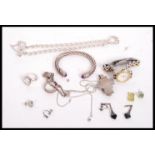 A collection of silver hallmarked and 925 costume jewellery to include a slave bangle set with