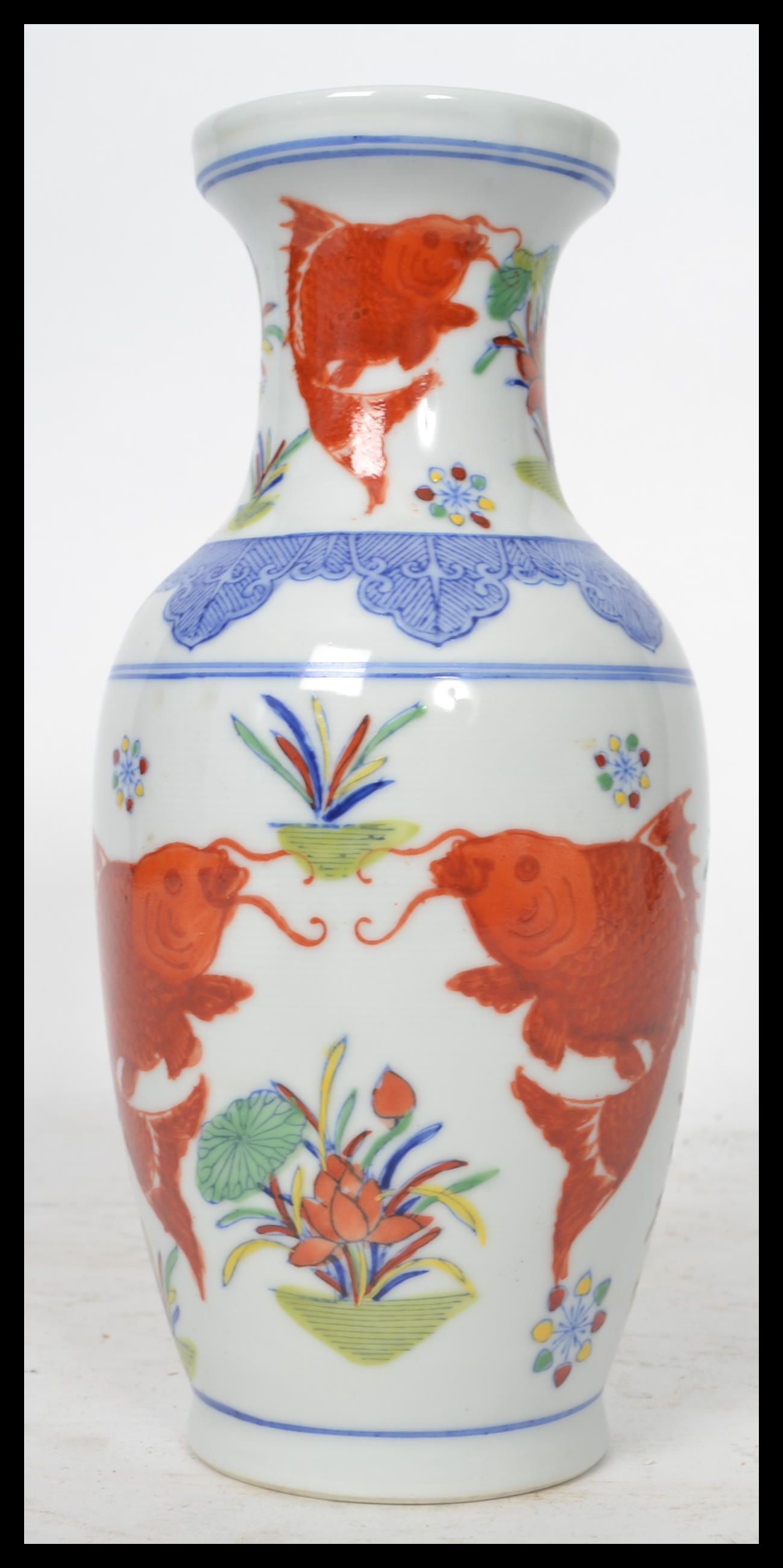 A 20th century Chinese vase decorated with scenes of carp and weeds with ochre red character marks - Image 3 of 6