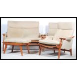 A retro 20th century Danish inspired three piece suite consisting of two armchairs and a matching