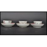 A group of three 18th century English famille rose tea bowls and saucers painted with pink ribbon