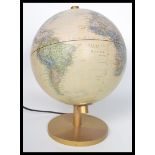 A retro 20th century illuminated terrestrial desk top globe raised on a gilt pedestal base, the