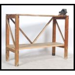 A vintage scratch built 20th century work bench, constructed from reclaimed pine planks, the top