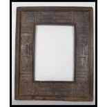 A vintage 20th century hard wood carved African picture frame, the frame heavily carved with African