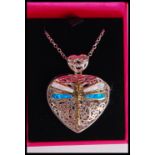 A silver and enamel heart locket pendant having a dragonfly to front. On silver chain and complete