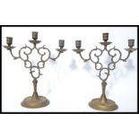 A 19th century Victorian cast brass pair of candelabra candlesticks's raised on stepped circular