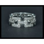 An 18ct white gold ring having interlocking sections of diamonds. Weighs 5 grams size P.