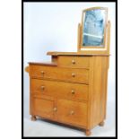 A 1930's Waring & Gillows solid oak dressing table / chest of drawers having an arrangement of