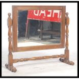 A 1920's oak dressing table swing mirror. Raised on block and turned legs with central stretcher and