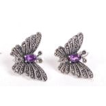 A pair of sterling silver and marcasite earrings in the form butterflies having amethyst stones.