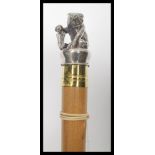 A 20th century walking stick cane having a tapering shaft with silver plated Swiss bear with