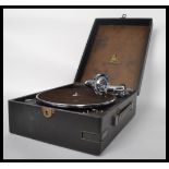 A vintage early 20th century portable gramaphone by Odeon. Set in the black carry case with deck and