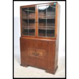 A 1930's Art Deco oak library bookcase cabinet. The glass display cabinet with shelved interior