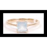 A hallmarked 9ct gold ring set with a square cut pale blue stone. Hallmarked Birmingham. Weight 2.