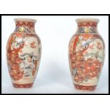 A pair of 19th century Japanese Satsuma vases, each of squat form having decorative scenes of
