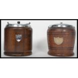 Two vintage 20th century oak biscuit barrels having silver white metal mounts and lids. One barrel