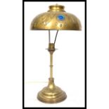 An early 20th century French brass table lamp having inset faceted purple stones to the shade.