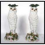 A pair of 19th century Victorian Majolica candlesticks in the form of owls raised on naturalistic