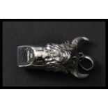 A sterling silver whistle in the form of  a bulls head with horns and bail loop. Weighs 17 grams.