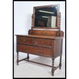 A 1920's Jacobean revival oak dressing chest of drawers. The chest with short and deep drawers