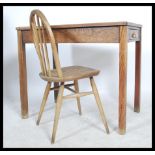 A vintage 20th century teachers school desk, single drawer to front with brass cup handle, raised on